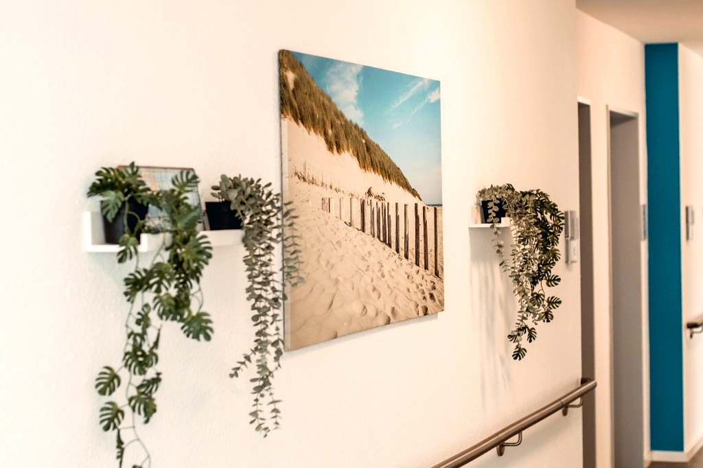 Flurgestaltung mit stimmungsvollem Strand-Wandbild, Zimmerpflanzen und behaglicher Atmosphäre